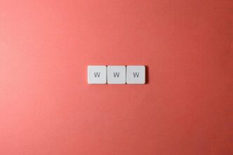 Close-up of WWW keyboard keys on a vibrant red surface, ideal for digital concepts.