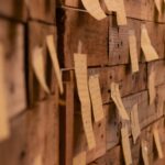 a wooden wall with post it notes attached to it