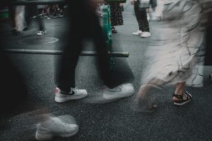 A group of people walking down a street